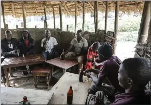  ?? (AP/Hajarah Nalwadda) ?? Local patrons share tonto at a bar in Majengo village, Mbarara, Uganda, in December.