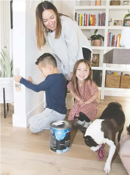  ?? WALTER TYCHNOWICZ/ WIRESHARP PHOTOGRAPH­Y ?? Amber Deng found that with a busy household including son Ethan, 7, daughter Ella, 6, and dog Mika, wear and tear was starting to show on her home's hardwood floors and rugs. She went online to get quotes on replacing the flooring.