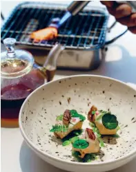  ??  ?? New inspiratio­ns from the region have led to dishes like this serving of foie gras and Japanese abalone paired with smoked eel torched tableside
