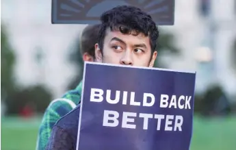  ?? JEMAL COUNTESS/GETTY IMAGES ?? A young man holds a sign in support of the Build Back Better bill at a rally on Thursday, a day before the House passed the legislatio­n.