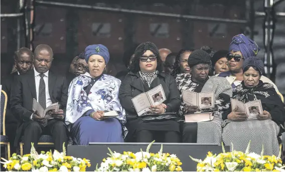  ?? Picture: AFP ?? SOMBRE. Deputy President David Mabuza, left, and Zenani and Zindzi Mandela attend a memorial service for Winnie Madikizela-Mandela at Orlando Stadium in Soweto yesterday.