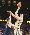  ?? GETTY GREGORY SHAMUS/ ?? Zach Edey of Purdue takes a shot over Hunter Dickinson of Michigan on Thursday.
