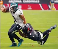  ?? Photo: AP ?? Philadelph­ia Eagles quarterbac­k Jalen Hurts tries to fend off Arizona Cardinals linebacker Isaiah Simmons during their NFL game.