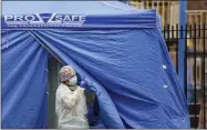  ?? JOHN MINCHILLO ?? Medical works operate a testing tent at a COVID- 19mobile testing site, Wednesday, Nov. 11, 2020, in the Brooklyn borough of New York. More people tested positive for the virus across the state Monday, another high since the early spring.