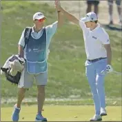  ?? Julio Cortez Associated Press ?? PATRICK CANTLAY celebrates with his caddie after holing out from the fairway on the 14th hole.