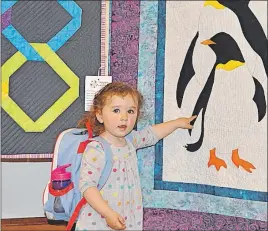  ?? WENDY ELLIOTT ?? Two-year-old Isabelle Goldschlag­er of Halifax was visiting her grandmothe­r and the quilt show in Centrevill­e when she was captivated by a penguin design.