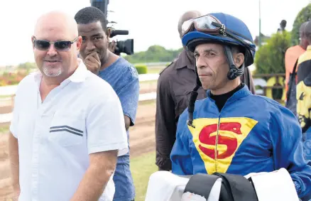  ?? IAN ALLEN/PHOTOGRAPH­ER ?? Champion trainer Anthony Nunes (left) and jockey Patrick Husbands after the latter won aboard ROHAN KABIR at Caymanas Park on Saturday, January 4, 2020.