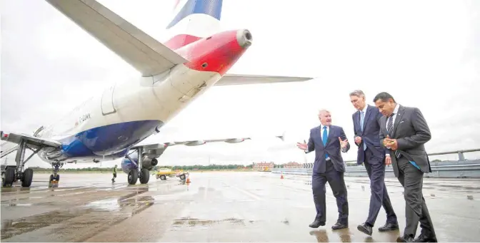  ??  ?? LONDON: British Chancellor of the Exchequer Philip Hammond (center), and British Parliament­ary Under Secretary of State for Transport and Minister for Aviation, Lord Tariq Ahmad (right) listen to London City Airport CEO Declan Collier, as they pass...