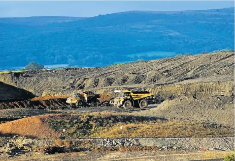  ?? /Bloomberg ?? Groundwork: Dumper trucks shift earth at the constructi­on site of the Hinkley Point C nuclear power station in the UK. The British government agreed in 2016 to pay, for no fewer than 35 years, a guaranteed price for electricit­y which is more than twice...