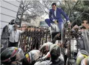  ?? Matias Delacroix / Associated Press ?? Venezuelan opposition leader Juan Guaidó climbs a fence in a failed attempt to enter the country’s congress, as he was blocked from a special session.