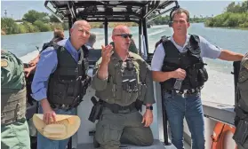  ?? PROVIDED PHOTO ?? Gov. Kevin Stitt receives a tour of the U.S.-Mexico border via boat. The tour was part of the governor's Oct. 6 trip to the border that included a news conference with eight other Republican governors.
