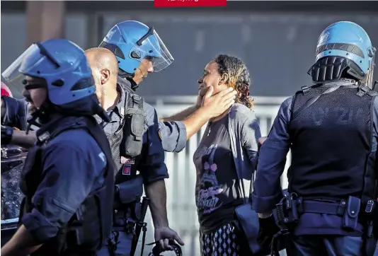  ??  ?? SGOMBERARE Un poliziotto consola una rifugiata durante uno sgombero in piazza Indipenden­za a ROMA.