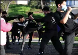  ?? PHOTO BY AXEL KOESTER ?? Kevin Leung, head instructor, leads a practice of the Kong's Siu Lum Pai Kung Fu Associatio­n at Garvey Ranch Park playground in Monterey Park on Sunday.