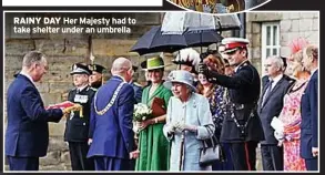  ?? ?? RAINY DAY Her Majesty had to take shelter under an umbrella