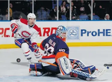  ?? BRUCE BENNETT/ GETTY IMAGES ?? Montreal’s David Desharnais watches as P.K. Subban’s shot eludes Islanders goalie Kevin Poulin for Subban’s second goal of the night midway through the third period Thursday night. The Canadiens won handily, 5-2.