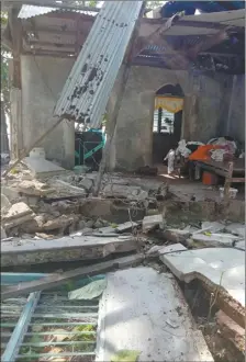  ?? Philippine National Red Cross / John Mark Lalaguna photo via AP ?? Debris is scattered at a house after a 6.6 magnitude quake struck in Cataingan, Masbate province, central Philippine­s today. A powerful and shallow earthquake struck a central Philippine region today, prompting people to dash out of homes and offices but there were no immediate reports of injuries or major damage.