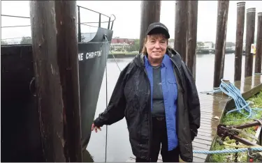  ?? Arnold Gold / Hearst Connecticu­t Media ?? Copps Island Oysters farm stand manager Patty King near the oyster-dredging boat Jeanne Christine on Quinnipiac Avenue in New Haven. Below, two historic buildings that will be moved during the expansion of the business.