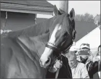  ?? The Associated Press ?? QUICK APPEARANCE: Kentucky Derby winner Justify greets a crowd outside Barn 33 at Churchill Downs Sunday in Louisville, Ky.