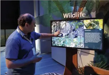  ?? ANICK JESDANUN — THE ASSOCIATED PRESS ?? Lilian Pintea, chief scientist with the Jane Goodall Institute, demonstrat­es features on Google Earth, in New York. Google Earth is getting a revival, with the mapping service becoming more of a tool for adventure and exploratio­n. Google has partnered...