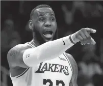  ?? CURTIS COMPTON/TRIBUNE NEWS SERVICE ?? The Los Angeles Lakers' LeBron James directs his team against the Atlanta Hawks on February 12 in Atlanta.