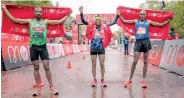  ??  ?? Kitata celebrates winning the elite men’s race with Kenya’s Kipchumba and Ethiopia’s Martin at the London Marathon