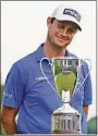  ?? John Minchillo / Associated Press ?? Harris English looks at the trophy after winning the Travelers Championsh­ip in a playoff at TPC River Highlands on June 27 in Cromwell.