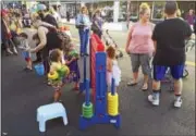  ?? PHOTOS BY BEN LAMBERT — THE REGISTER CITIZEN ?? Kiddie games were among the activities to be found at this summer’s Main Street Marketplac­e.