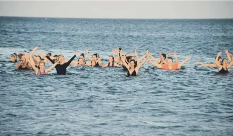  ??  ?? Members of the Wild Sea Women group enjoy their last North Sea dip together before the new rules capped the number of people allowed to socialise