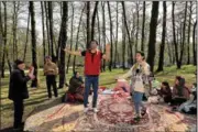  ?? (AP/Ebrahim Noroozi) ?? People in Gisoum forest near the Iranian city of Talesh dance and play music Friday while enjoying the annual public picnic day on the last day of the Persian New Year.