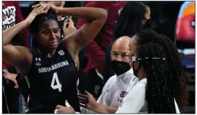  ?? (AP/Eric Gay) ?? Stanford forward Francesca Belibi (right) and Haley Jones try to console South Carolina forward Aliyah Boston after the Cardinal’s 66-65 victory over the Gamecocks in the women’s NCAA Tournament Final Four at the Alamodome in San Antonio. Stanford advanced to its first national title game since 2010. More photos at arkansason­line.com/43ncaawome­n/.