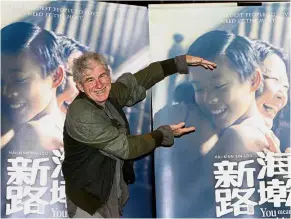  ??  ?? Lights, camera, action: Doyle posing with a poster of ‘ You Mean The World To Me’ in Kuala Lumpur.