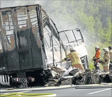  ?? Picture: REUTERS ?? CHARRED WRECKAGE: Firefighte­rs and rescue workers busy at the site where the bus burst into flames near the Bavarian town of Stammbach after a horrific accident