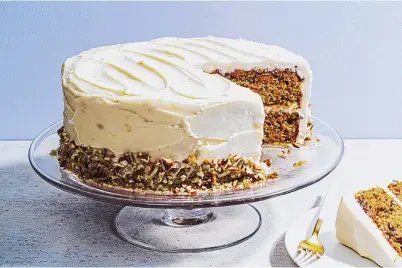  ?? SCOTT SUCHMAN/FOR THE WASHINGTON POST ?? Carrot cake with brown butter-cream cheese frosting features golden raisins, with their sweet honey notes, and toasted pecans, very finely chopped.