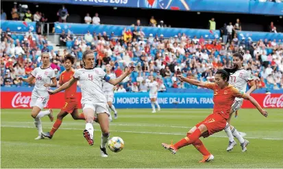  ??  ?? China’s Gu Yasha (right) shoots at goal against Spain in the women’s World Cup Group B game on Monday at the Stade Oceane in Le Havre, France. — Reuters