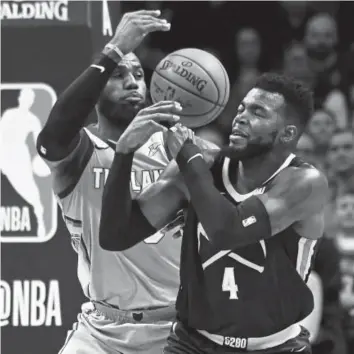  ?? John Leyba, The Denver Post ?? Cavaliers star LeBron James steals the ball from the Nuggets’ Paul Millsap during Wednesday night’s game at the Pepsi Center. The Nuggets are only 2-3 since Millsap returned to action after recovering from wrist surgery. And they’re on the outside of...