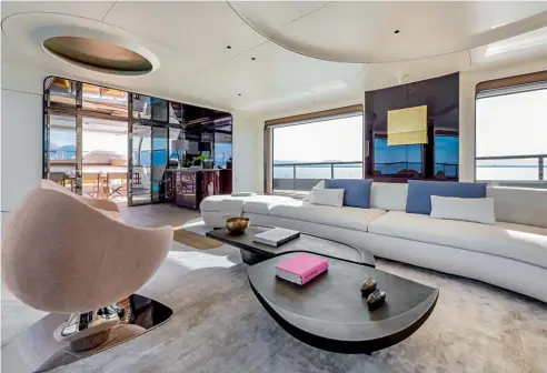  ??  ?? Below: in place of L-shaped sofas and rectangula­r coffee tables is one long, curved settee and freeflowin­g low tables.
Previous spread: Grande Trideck marks Azimut’s foray into futuristic yacht design and planning.