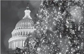  ?? ALEX WONG/GETTY IMAGES ?? The 80-foot Capitol Christmas tree, an Engelmann spruce, is decorated with LED lights and 6,000 ornaments made from recycled material by Idaho schoolchil­dren.