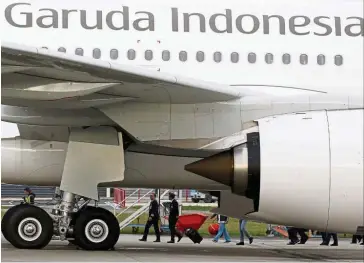  ??  ?? Govt aid: A file picture showing a Garuda Indonesia Airbus A330 aircraft parked at Airbus headquarte­rs in Colomiers near Toulouse, France. The airline will receive 8.5 trillion rupiah in working capital investment­s, according to the documents. — Reuters