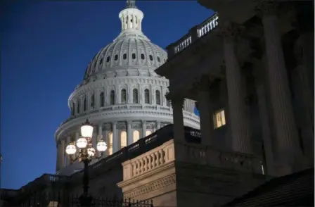  ?? ASSOCIATED PRESS ?? The Capitol is seen at day’s end as the Senate works on a House-passed bill that would pay for President Donald Trump’s border wall and avert a partial government shutdown, at the Capitol in Washington.