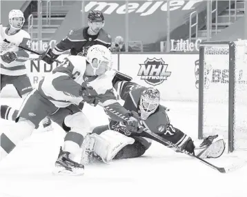  ?? PAUL SANCYA AP ?? Panthers goalie Sergei Bobrovsky works to fend off Red Wings center Dylan Larkin in the second period of Saturday’s game. Bobrovsky stopped 25 shots and fell to 5-2-1 on the season.