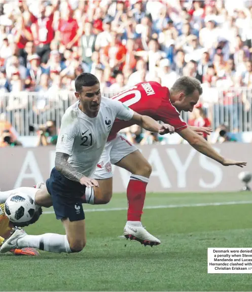  ?? AP ?? Denmark were denied a penalty when Steve Mandanda and Lucas Hernandez clashed with Christian Erisksen