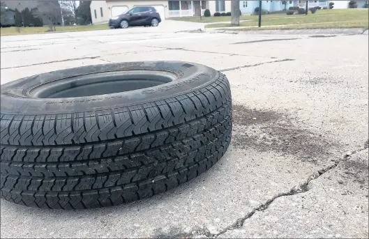  ?? JERRY DAVICH/POST-TRIBUNE ?? Post-Tribune columnist Jerry Davich ran over this truck-size spare tire on a street near his home. The tire apparently fell off a vehicle without the driver’s knowledge.