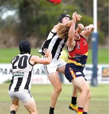  ?? ?? Poowong’s Tom Robertson spoils this marking attempt by a Longwarry player.