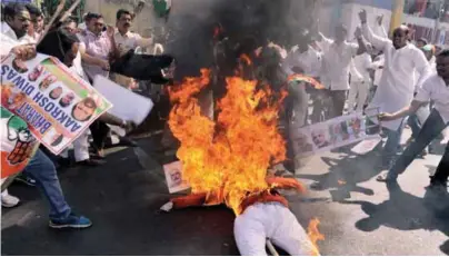  ??  ?? ... Members of the Congress party burn an effigy representi­ng Indian Prime Minister Narendra Modi in Hyderabad yesterday. Tens of thousands of people turned out for nationwide protests against India’s controvers­ial ban on high-value banknotes, which...