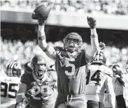  ?? Tom Pennington / Getty Images ?? Baylor linebacker Dillon Doyle celebrates after scoring the first of his two touchdowns Saturday.