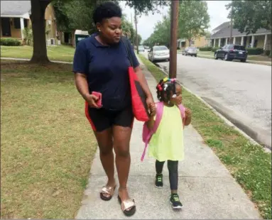  ?? JULIET LINDERMAN — THE ASSOCIATED PRESS ?? In this May 17, 2018 photo, Shannon Brown, 29, walks with her four-year-old daughter, Sai-Mya, in Charleston, S.C. Brown lives in public housing and could face a steep increase under a HUD proposal that would raise rents for millions of lowincome individual­s and families.