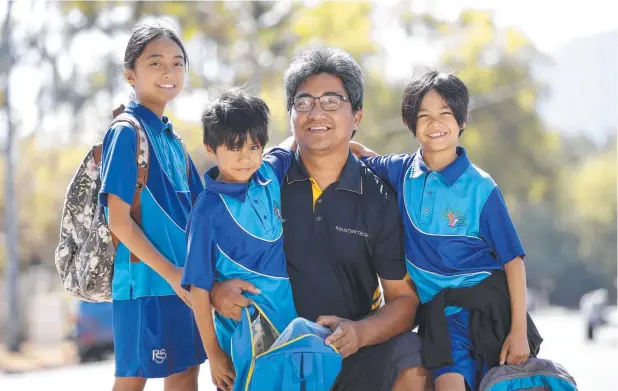  ?? Picture: ANNA ROGERS ?? GOOD CLASS SIZES: Rollie Agcalao and his children Meryl, 9, Mike Louis, 6, and Miguel, 8, who are students at Parramatta State School in Cairns.