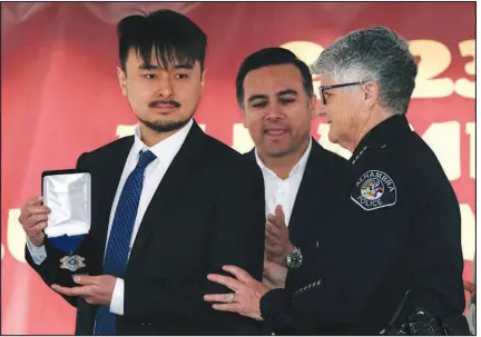  ?? RICHARD VOGEL / ASSOCIATED PRESS ?? Tsay displays a Metal of Courage award after it was presented to him Jan. 29 by Alhambra Police Chief Kelley Fraser in Alhambra, Calif. Tsay disarmed the Monterey Park dance hall killer as he stalked a second dance hall in Alhambra.