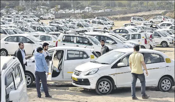  ?? SANJEEV VERMA/HT PHOTO ?? Unlike in India, where a Delhi high court order described the relationsh­ip between drivers and companies as ‘purely contractua­l’, which limits benefits to them, courts in the US and UK have sided with drivers, ruling that Uber must consider them as...