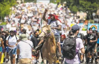  ?? Ricardo B. Brazziell / Associated Press ?? Protesters gather and march peacefully from Huston-Tillotson University to the State Capitol while chanting “Black Lives Matter” and “Justice,” on Sunday in Austin, Texas.